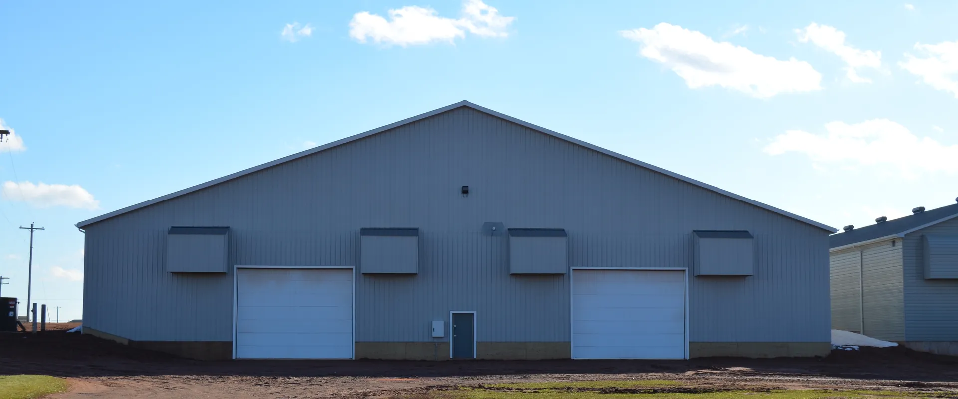 Finished Shorelane Farms agricultural building under a clean PEI sky
