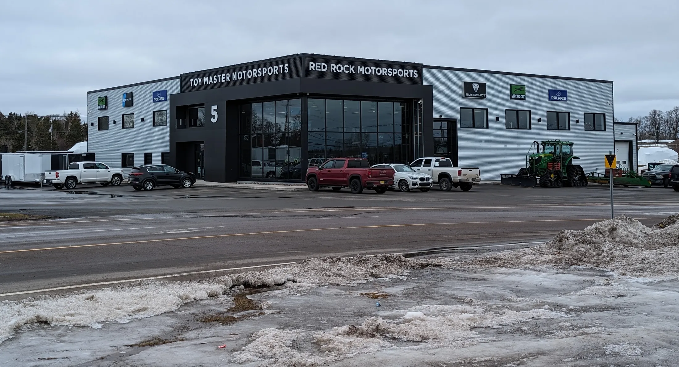 A finished commercial storefront with a covered timber entryway