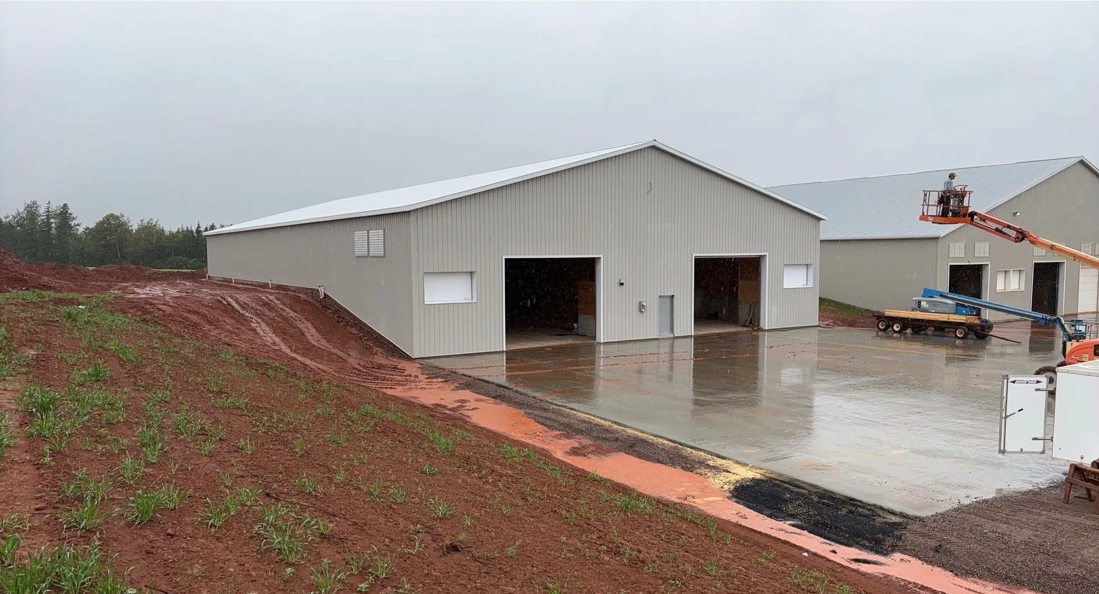 Two finished storage buildings with a poured concrete apron