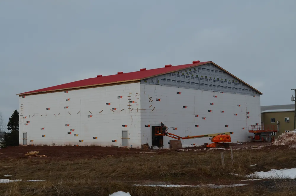 Potato storage warehouse under construction with a red roof