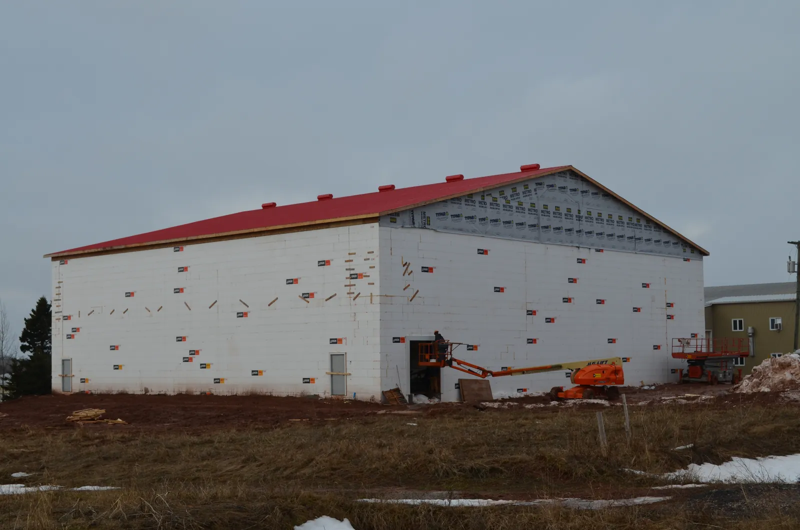 The Sherwood storage building during the build, wrapped with the red roof on